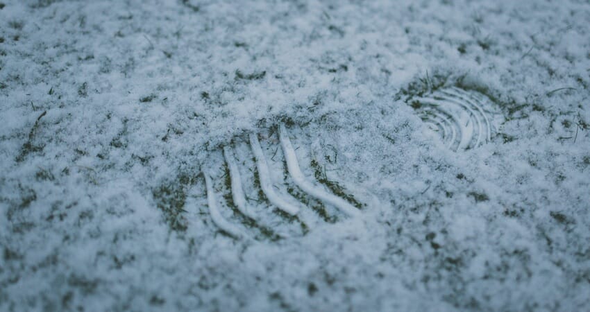 Photo of a footprint in snow.
