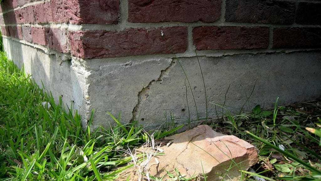 A cracked wall showing foundation problems vs. settling.